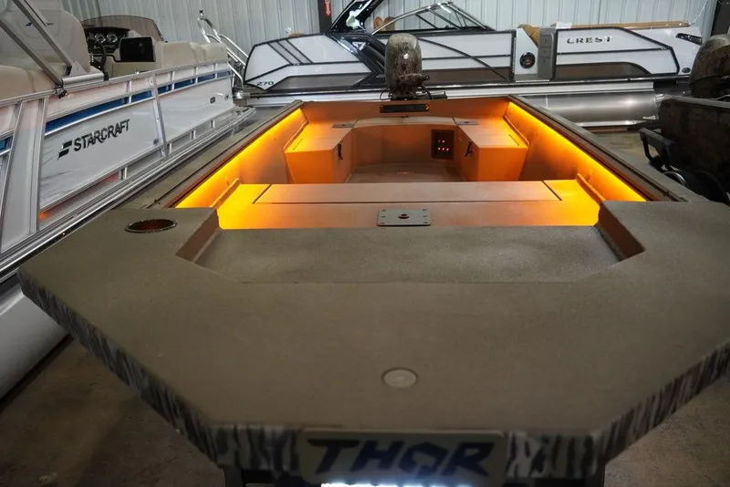 Slide: The Image of 2024 Thor Lake Hammer 1754 boat with illuminated interior, displayed in a showroom. - 4