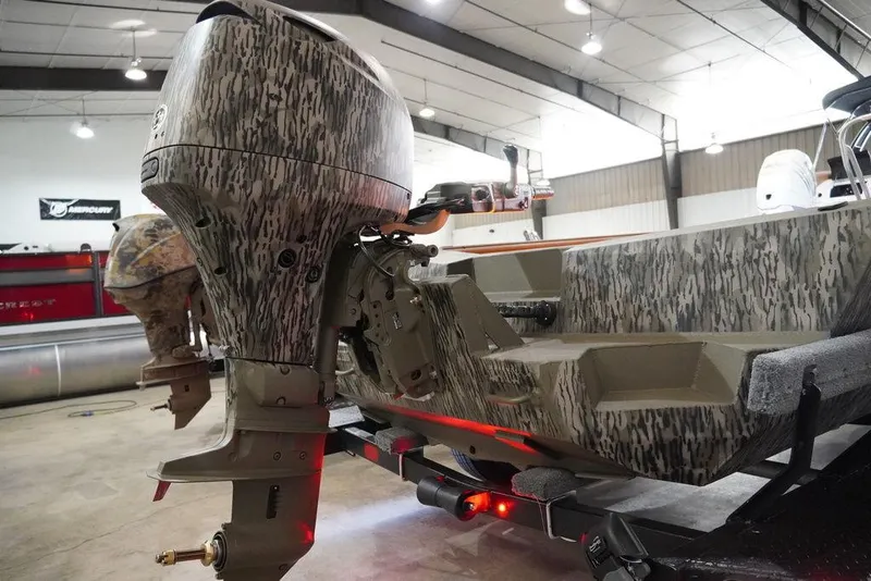 Slide: The Image of 2024 Thor Lake Hammer 1754 boat with camouflage design in a showroom. - 5