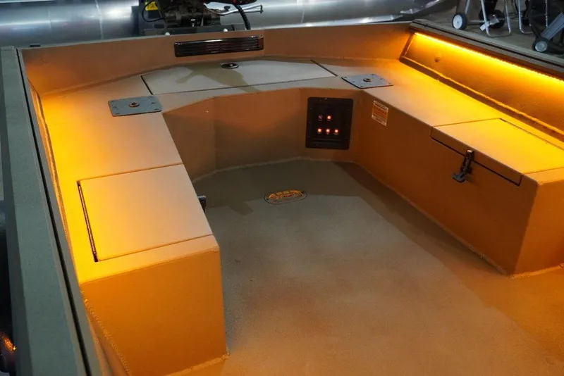 Slide: The Image of 2024 Thor Lake Hammer 1754 boat interior with orange lighting and seating area. - 6
