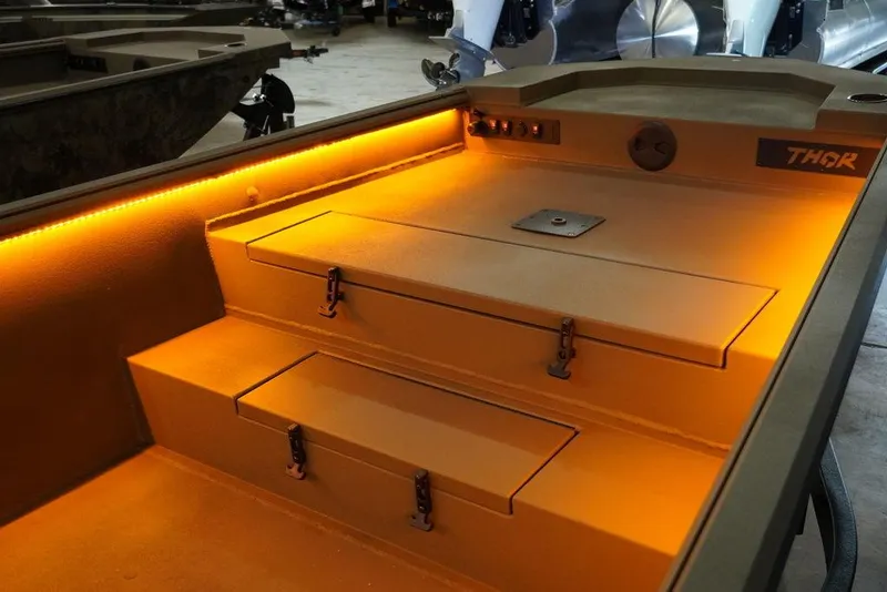 Slide: The Image of 2024 Thor Lake Hammer 1754 boat interior with orange LED lighting. - 7