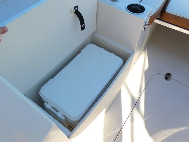 Slide: The Image of Storage compartment with cooler on 2024 Stingray 212 SC boat. - 12