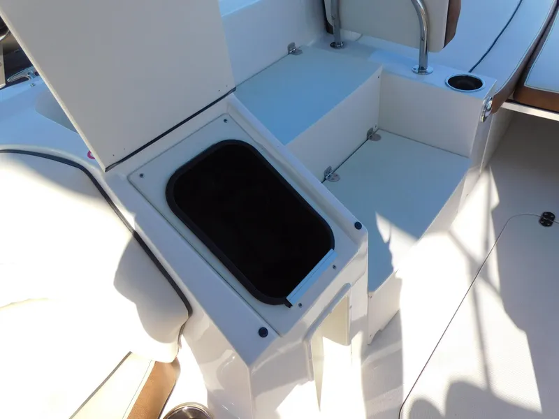 Slide: The Image of 2024 Stingray 212 SC boat interior storage compartment. - 16