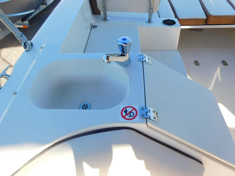 Slide: The Image of 2024 Stingray 212 SC boat sink and faucet in the cockpit area. - 17
