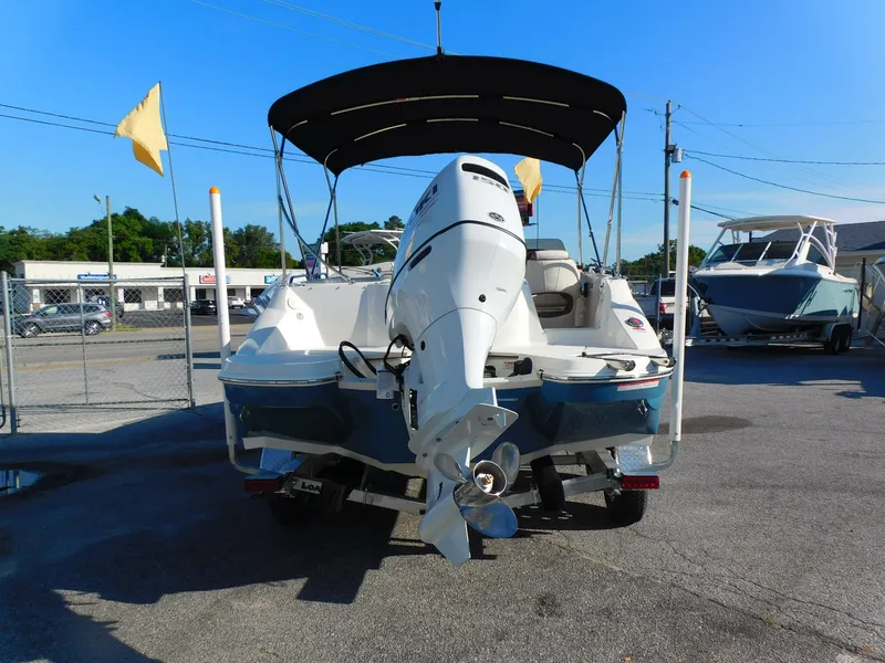 Slide: The Image of 2024 Stingray 212 SC boat with outboard motor and canopy, rear view. - 5