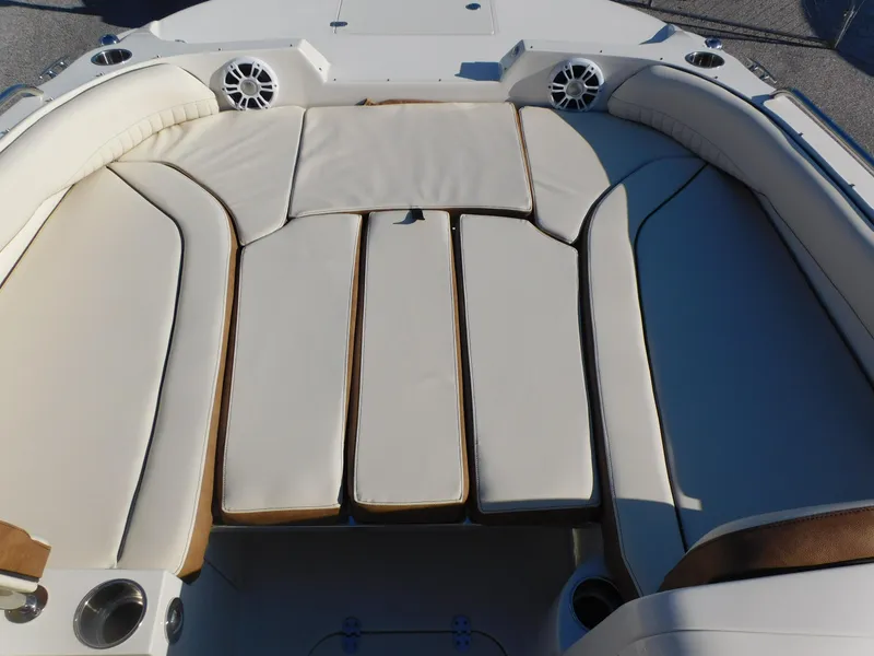 Slide: The Image of 2024 Stingray 212 SC boat with spacious cushioned seating area. - 6
