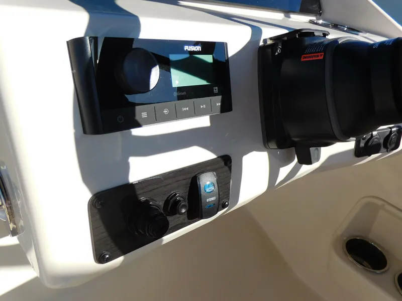Slide: The Image of 2024 Stingray 212 SC boat dashboard with Fusion audio system and controls. - 9
