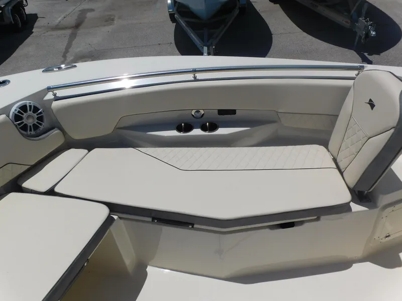 Slide: The Image of 2024 Stingray 253 CC boat with luxurious seating and cup holders. - 10