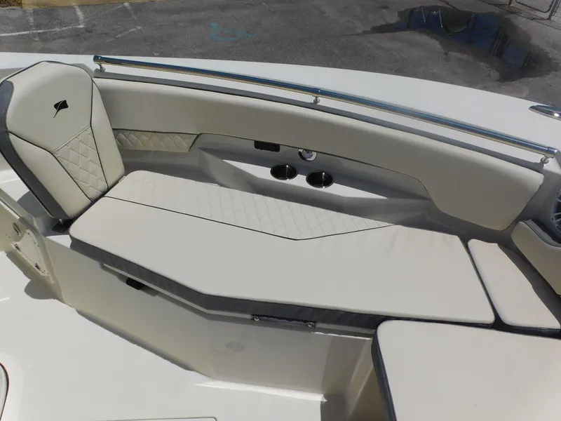 Slide: The Image of 2024 Stingray 253 CC boat interior with cushioned seating and stainless steel rail. - 12
