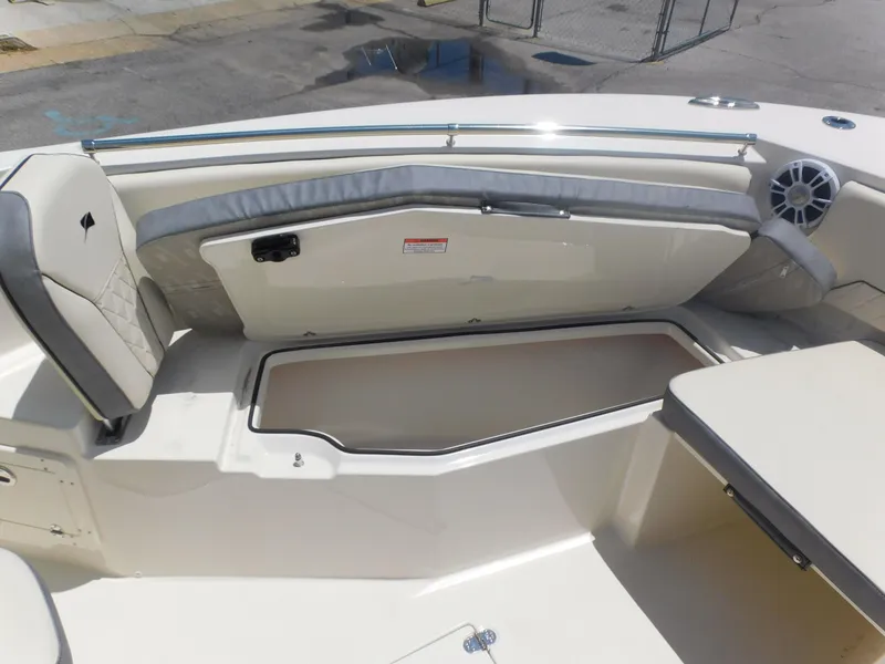 Slide: The Image of 2024 Stingray 253 CC boat interior with seating and storage compartment. - 15