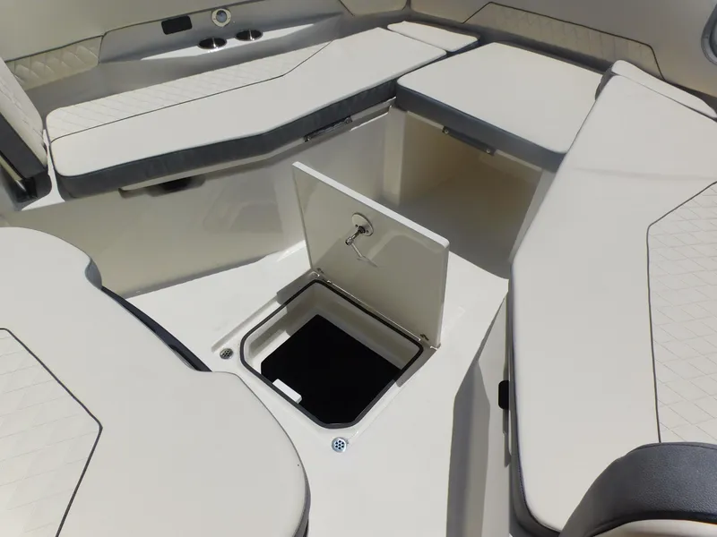 Slide: The Image of 2024 Stingray 253 CC boat interior with open storage compartment. - 17