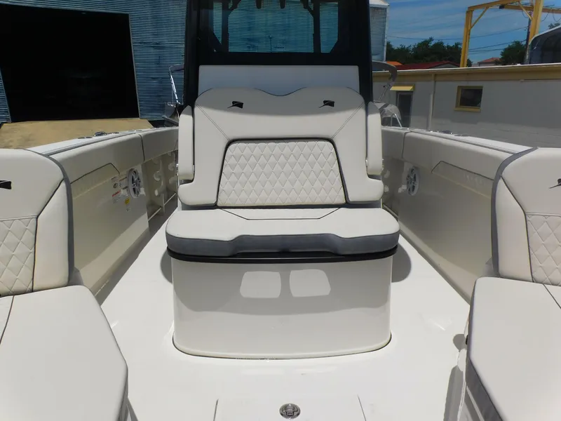 Slide: The Image of 2024 Stingray 253 CC boat interior with white cushioned seating. - 19