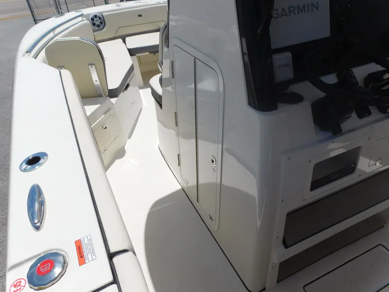 Slide: The Image of 2024 Stingray 253 CC boat interior with seating and storage compartments. - 24