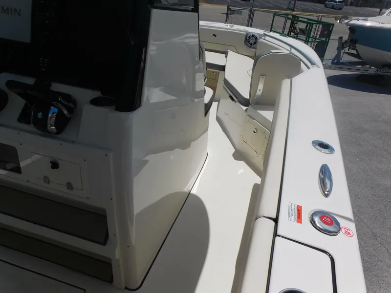Slide: The Image of 2024 Stingray 253 CC boat interior, featuring helm and seating area. - 25