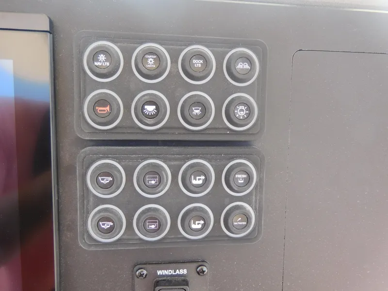 Slide: The Image of Control panel of 2024 Stingray 253 CC boat with various function buttons. - 28