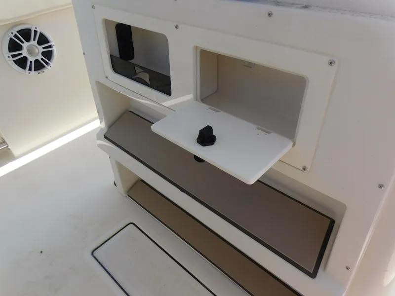 Slide: The Image of 2024 Stingray 253 CC boat storage compartments and speaker. - 35