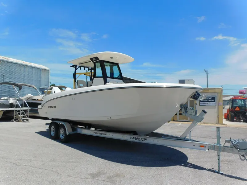 Slide: The Image of 2024 Stingray 253 CC boat on a trailer in a marina. - 5