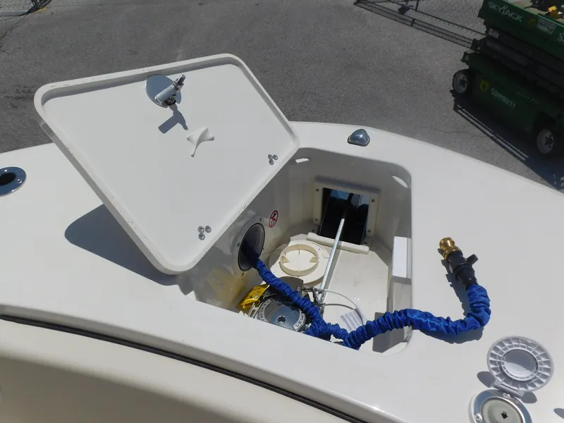 Slide: The Image of 2024 Stingray 253 CC boat storage compartment with hose and equipment. - 7