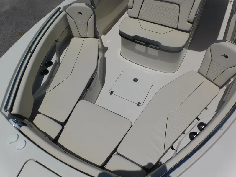 Slide: The Image of 2024 Stingray 253 CC boat interior with cushioned seating and storage compartments. - 9