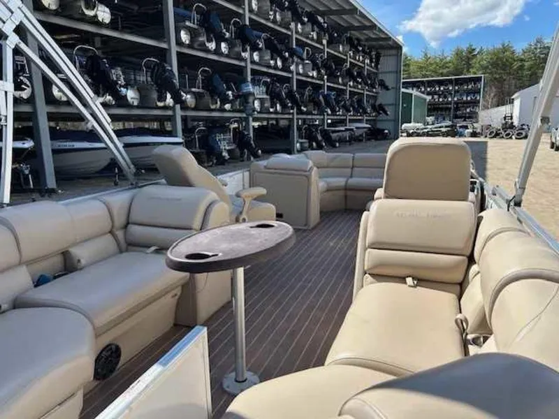 Slide: The Image of 2018 Berkshire 24RFX CTS pontoon boat with beige seating, docked at a marina. - 6