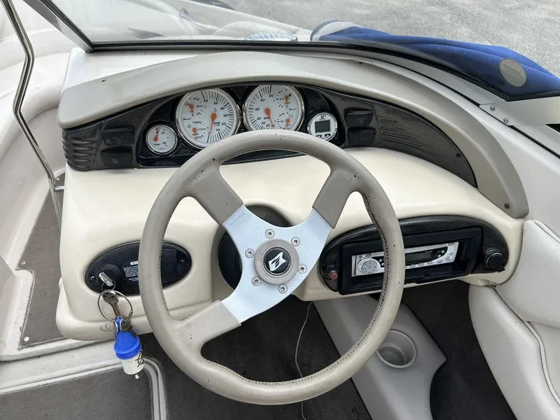 Slide: The Image of 2002 Larson SEi 190 boat dashboard with steering wheel and gauges. - 3
