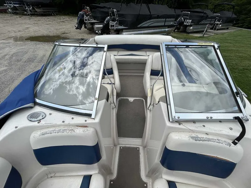 Slide: The Image of 2002 Larson SEi 190 boat interior with open windshield and seating. - 7