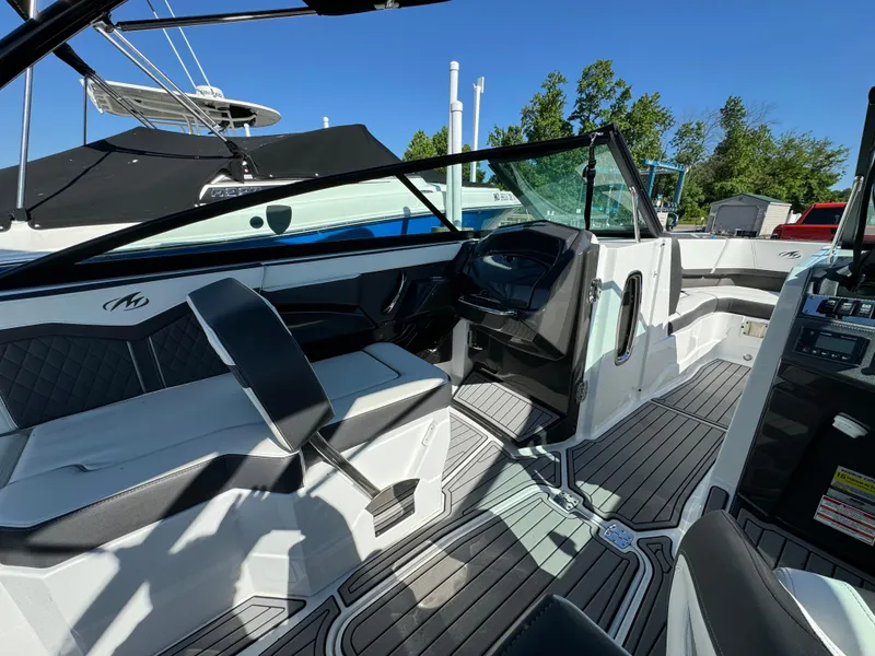 Slide: The Image of 2018 Monterey 258 Super Sport boat interior with seating and steering console. - 10
