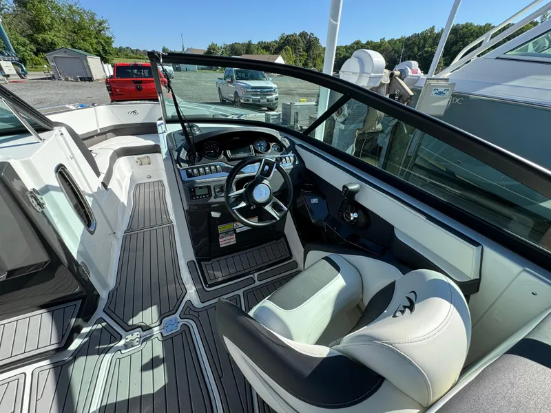 Slide: The Image of 2018 Monterey 258 Super Sport boat interior with steering wheel and seating. - 12
