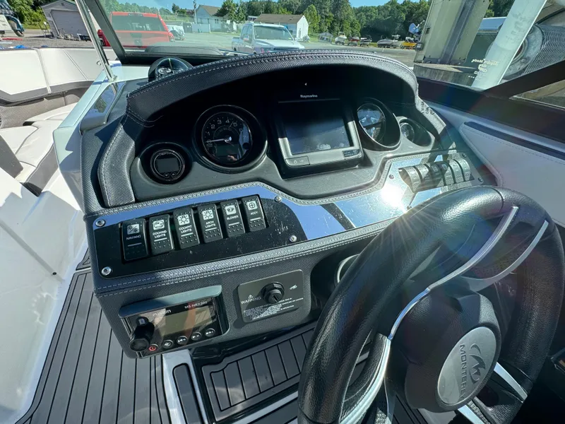 Slide: The Image of 2018 Monterey 258 Super Sport boat dashboard with steering wheel and control panel. - 13