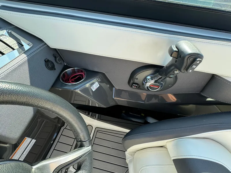 Slide: The Image of 2018 Monterey 258 Super Sport boat interior, steering wheel, and throttle control. - 14