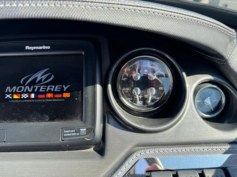 Slide: The Image of 2018 Monterey 258 Super Sport dashboard with Raymarine display and speedometer. - 16