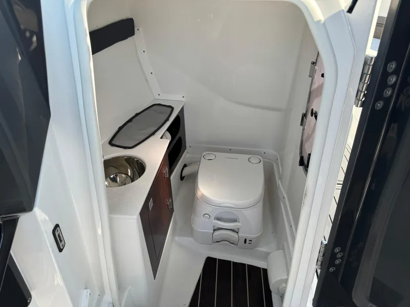 Slide: The Image of Interior of 2018 Monterey 258 Super Sport boat bathroom with sink and toilet. - 18