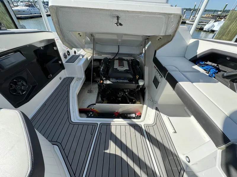 Slide: The Image of 2018 Monterey 258 Super Sport boat engine compartment with open hatch. - 23