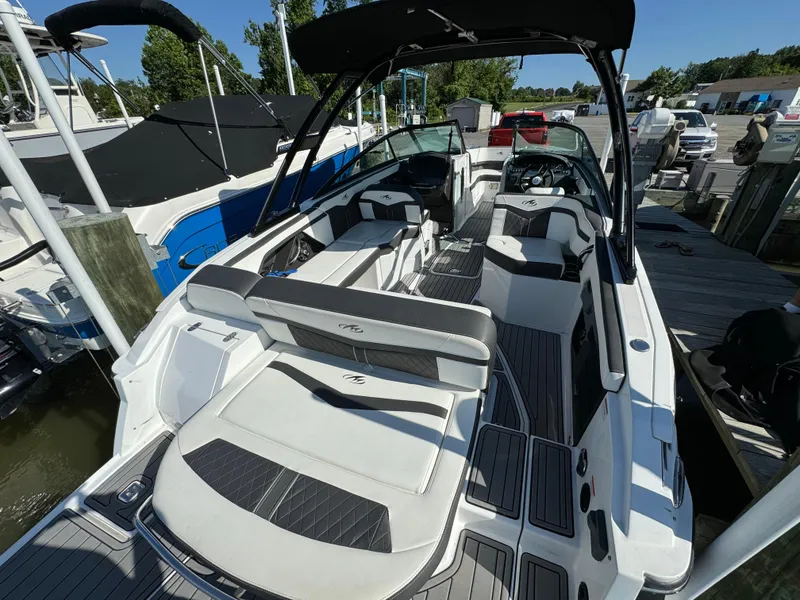 Slide: The Image of 2018 Monterey 258 Super Sport boat with spacious seating and sleek design docked at marina. - 5