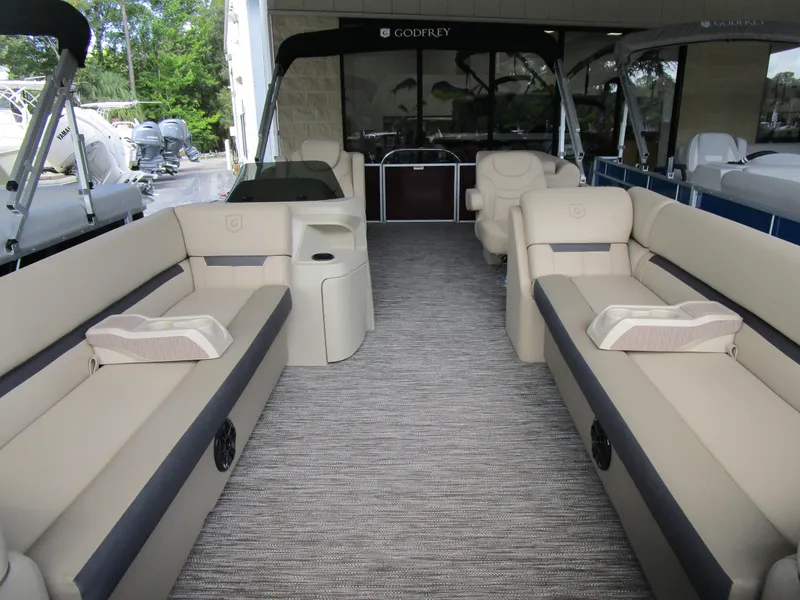 Slide: The Image of 2024 Sweetwater Split Bench SW 2286 SB pontoon boat interior with beige seating. - 3