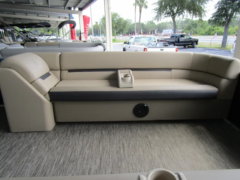 Slide: The Image of 2024 Sweetwater Split Bench SW 2286 SB pontoon boat interior with beige and gray seating. - 4