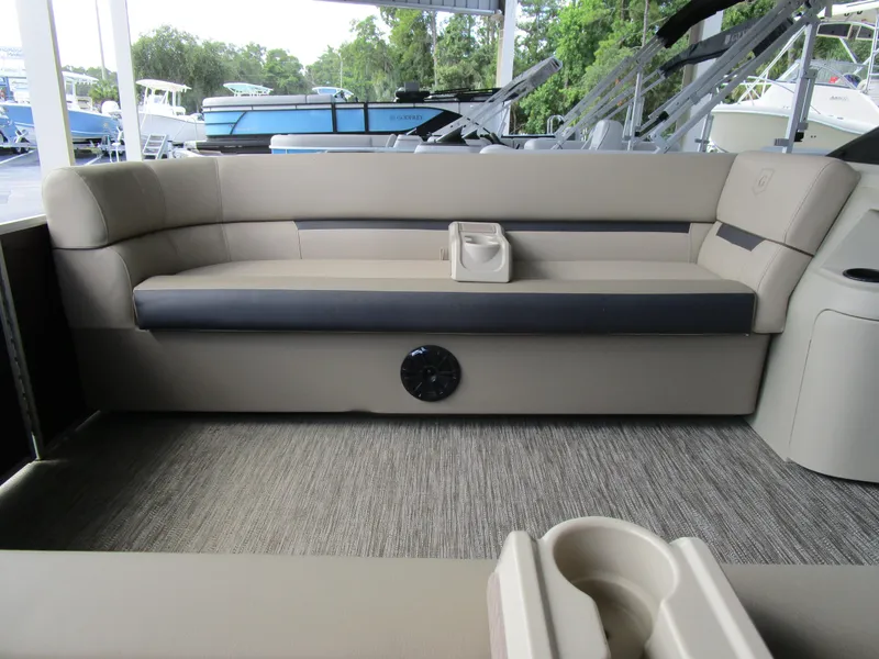 Slide: The Image of 2024 Sweetwater Split Bench SW 2286 SB boat interior with beige and gray seating. - 5