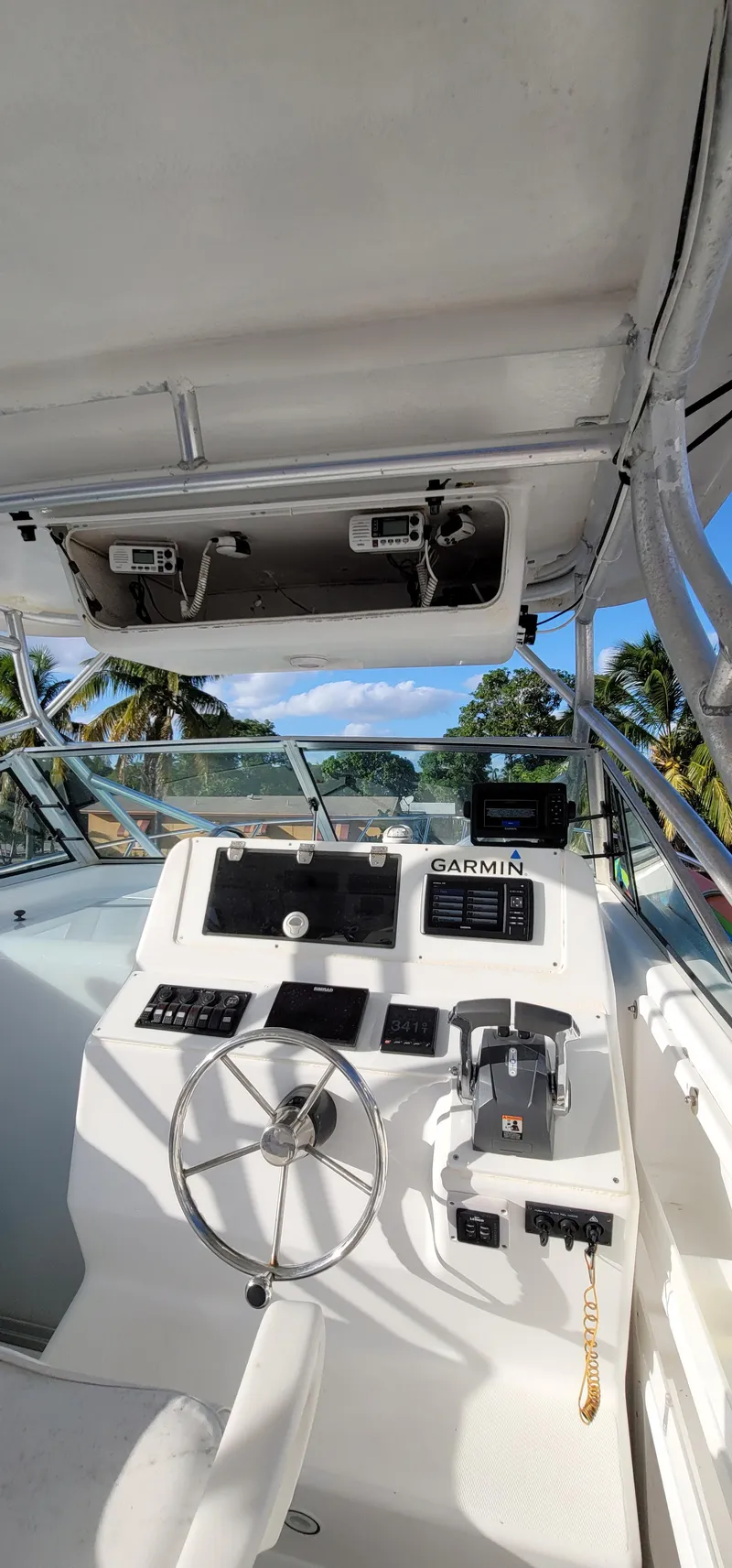 Slide: The Image of 2000 Pro-Line 29 Walkaround boat cockpit with steering wheel and Garmin navigation system. - 11
