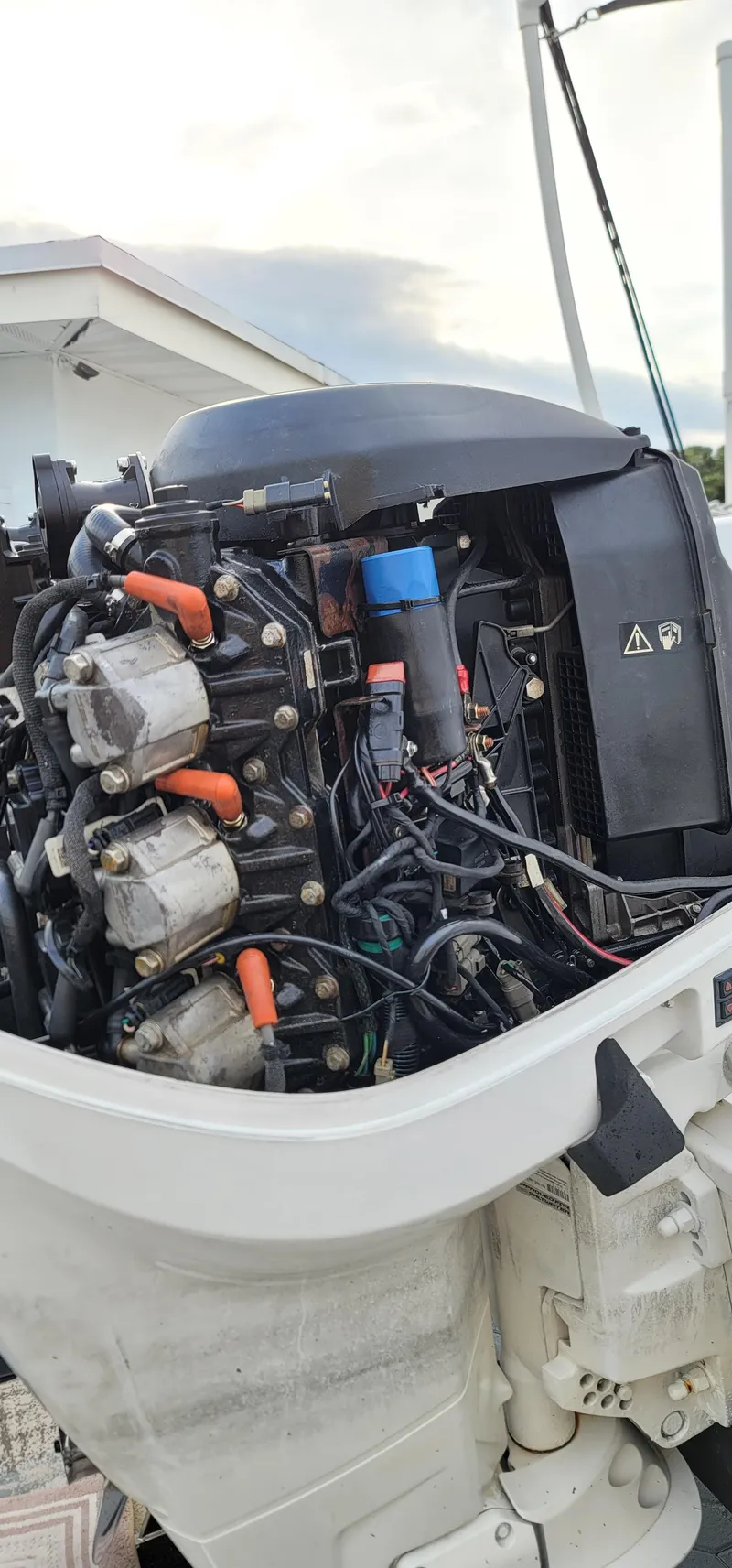 Slide: The Image of Close-up of a 2000 Pro-Line 29 Walkaround boat engine, showcasing intricate wiring and components. - 14
