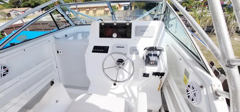 Slide: The Image of 2000 Pro-Line 29 Walkaround boat cockpit with steering wheel and navigation equipment. - 3