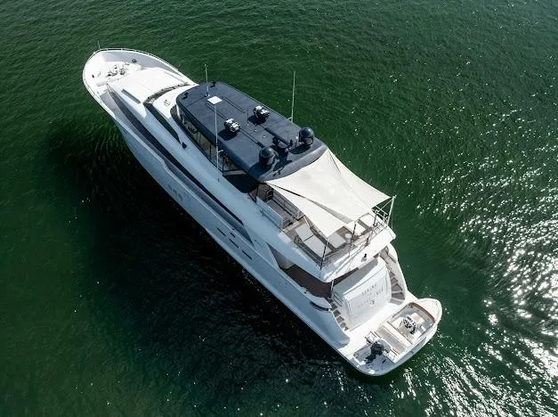 Slide: The Image of Aerial view of 2015 Hatteras 100 Raised Pilothouse yacht cruising on water. - 14