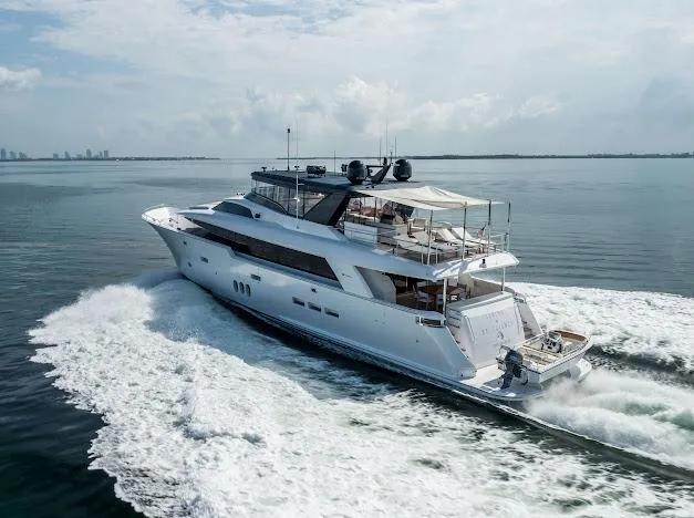 Slide: The Image of 2015 Hatteras 100 Raised Pilothouse yacht cruising on open water. - 17