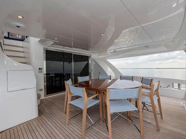 Slide: The Image of Outdoor dining area on 2015 Hatteras 100 Raised Pilothouse yacht with ocean view. - 20