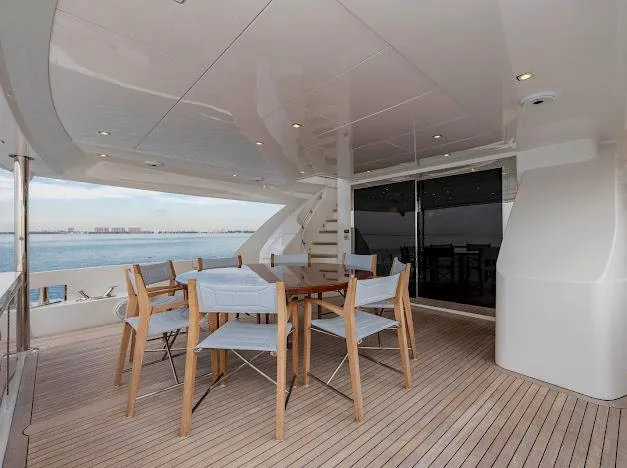 Slide: The Image of Luxury deck of 2015 Hatteras 100 Raised Pilothouse yacht with dining area. - 21