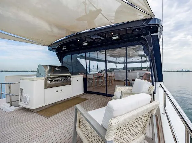 Slide: The Image of Luxury deck of 2015 Hatteras 100 Raised Pilothouse yacht with outdoor seating and grill. - 26