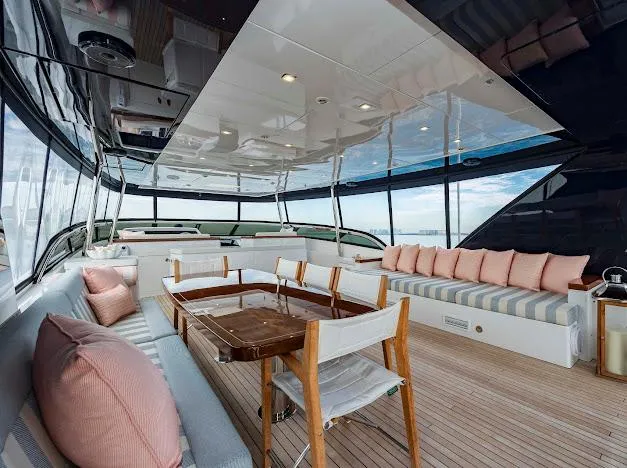 Slide: The Image of Luxurious interior of 2015 Hatteras 100 Raised Pilothouse yacht with elegant seating and dining area. - 29
