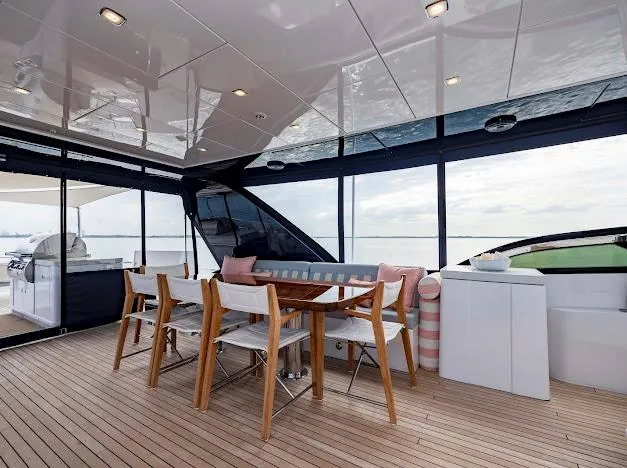 Slide: The Image of Luxury deck of 2015 Hatteras 100 Raised Pilothouse yacht with dining area. - 33