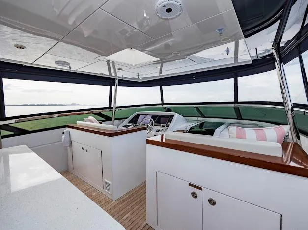 Slide: The Image of 2015 Hatteras 100 Raised Pilothouse yacht interior with modern helm and panoramic windows. - 39