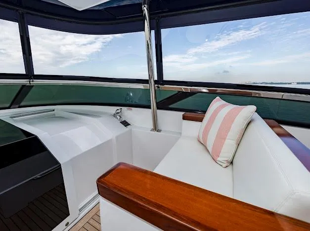 Slide: The Image of Interior of 2015 Hatteras 100 Raised Pilothouse yacht with white seating and striped pillow. - 46