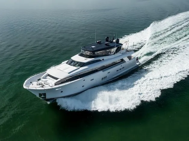 Slide: The Image of 2015 Hatteras 100 Raised Pilothouse yacht cruising on open water. - 7