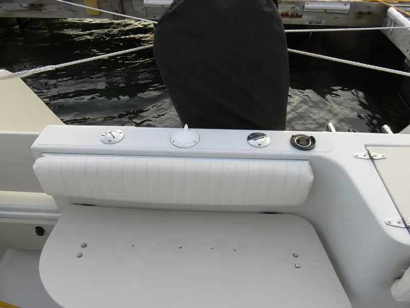 Slide: The Image of 1999 Stamas 250 Express boat interior with white seating and control panel. - 11